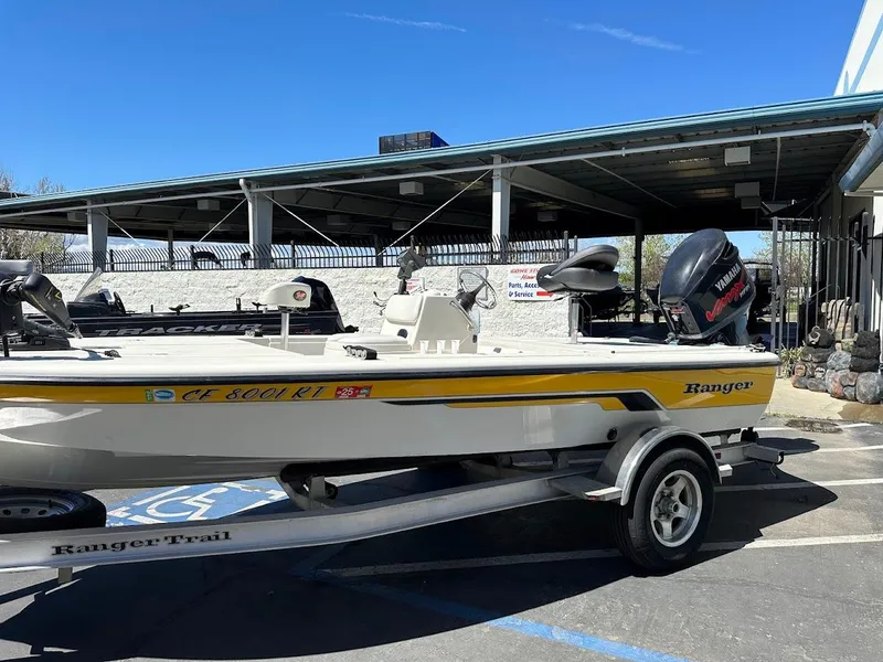Slide: The Image of 2007 Ranger 191 Cayman boat on trailer, parked outdoors under clear blue sky. - 7