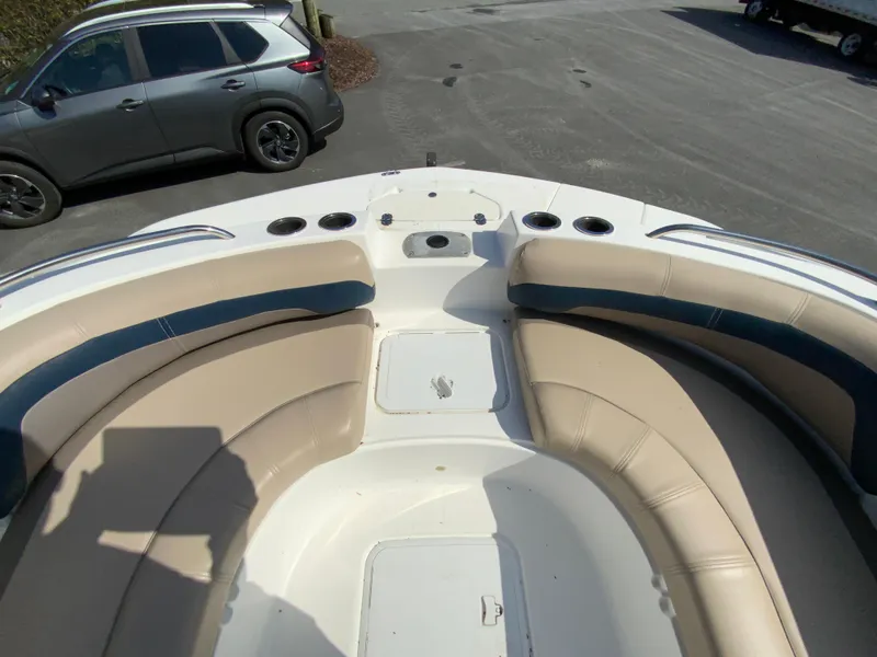 Slide: The Image of 2016 Hurricane Center Console 19 OB boat with beige seating and cup holders. - 13