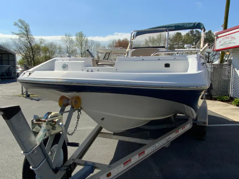 Slide: The Image of 2016 Hurricane Center Console 19 OB boat on trailer, parked outdoors. - 4