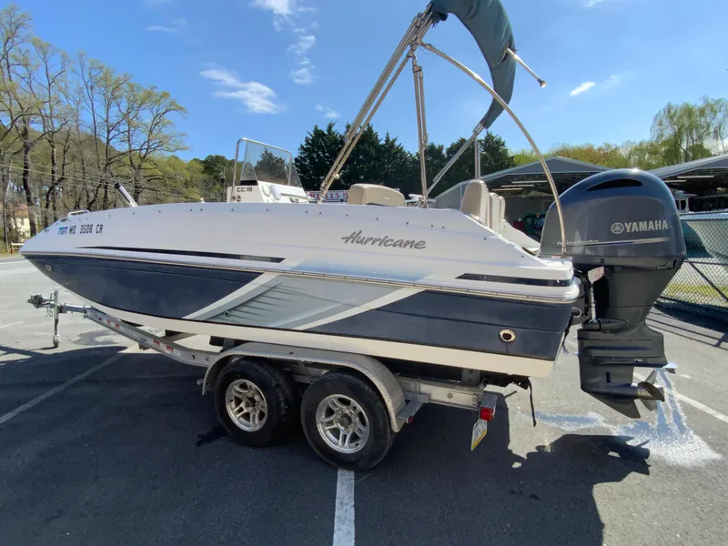 Slide: The Image of 2016 Hurricane Center Console 19 OB boat on trailer, parked outdoors. - 6