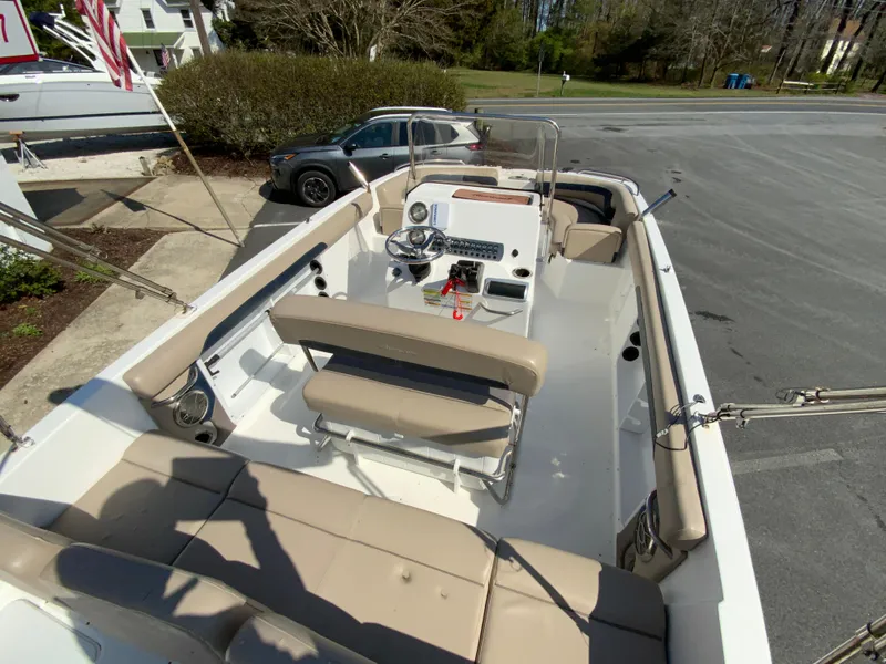 Slide: The Image of 2016 Hurricane Center Console 19 OB boat with beige seating and steering console. - 9