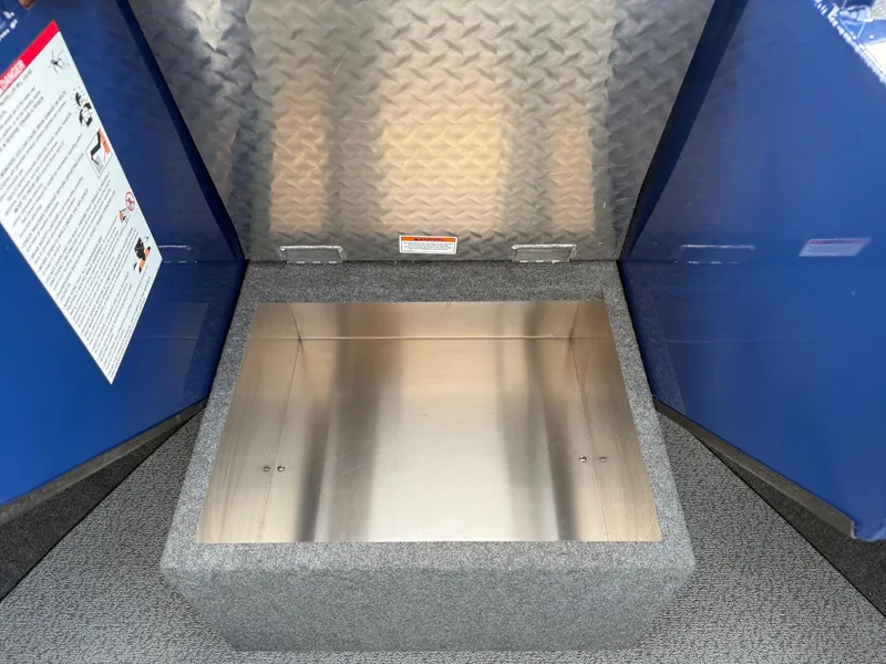 Slide: The Image of Storage compartment in 2025 Thunder Jet 185 Luxor boat, featuring diamond plate and carpeted interior. - 14