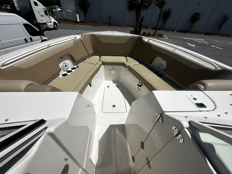 Slide: The Image of 2018 Sailfish 325DC boat interior with beige seating and cup holders. - 10