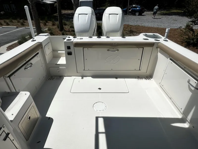Slide: The Image of 2018 Sailfish 325DC boat deck with storage compartments and twin engines. - 3