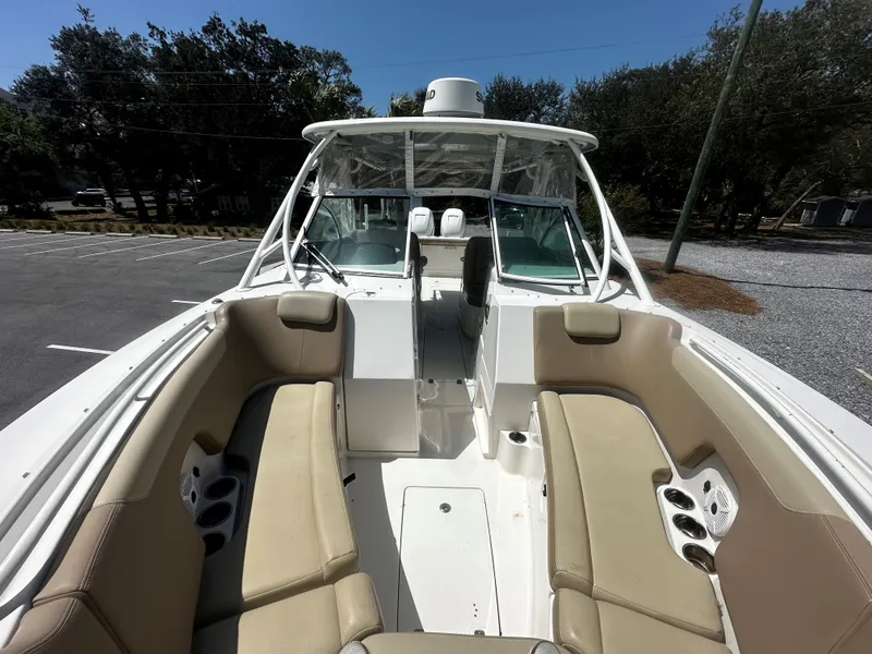 Slide: The Image of 2018 Sailfish 325DC boat with beige seating and spacious deck. - 4