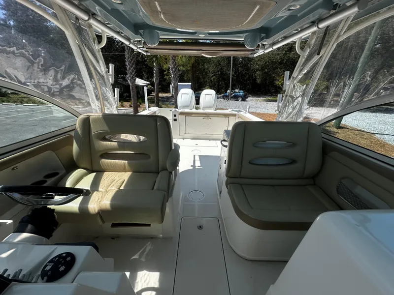 Slide: The Image of 2018 Sailfish 325DC boat interior with seating and steering wheel, showcasing spacious design. - 9
