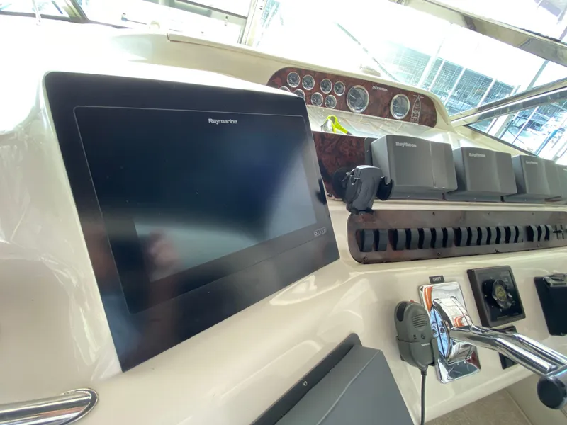 Slide: The Image of Cockpit dashboard of 1997 Sea Ray 450 Sundancer with navigation equipment and controls. - 10
