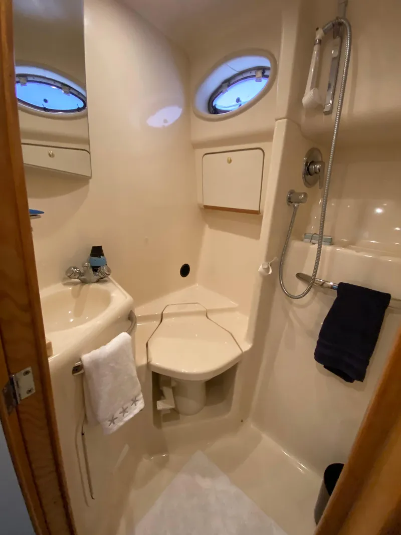 Slide: The Image of Bathroom interior of 1997 Sea Ray 450 Sundancer yacht, featuring shower and sink. - 24
