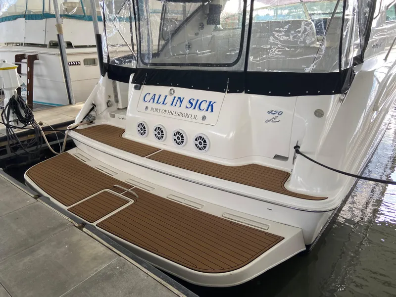 Slide: The Image of 1997 Sea Ray 450 Sundancer docked, featuring "Call In Sick" nameplate. - 4