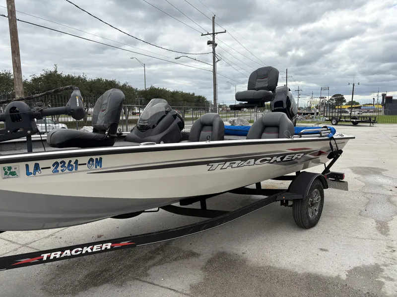 Slide: The Image of 2021 Tracker Pro Team 175 Tournament boat on trailer, parked outdoors under cloudy sky. - 7