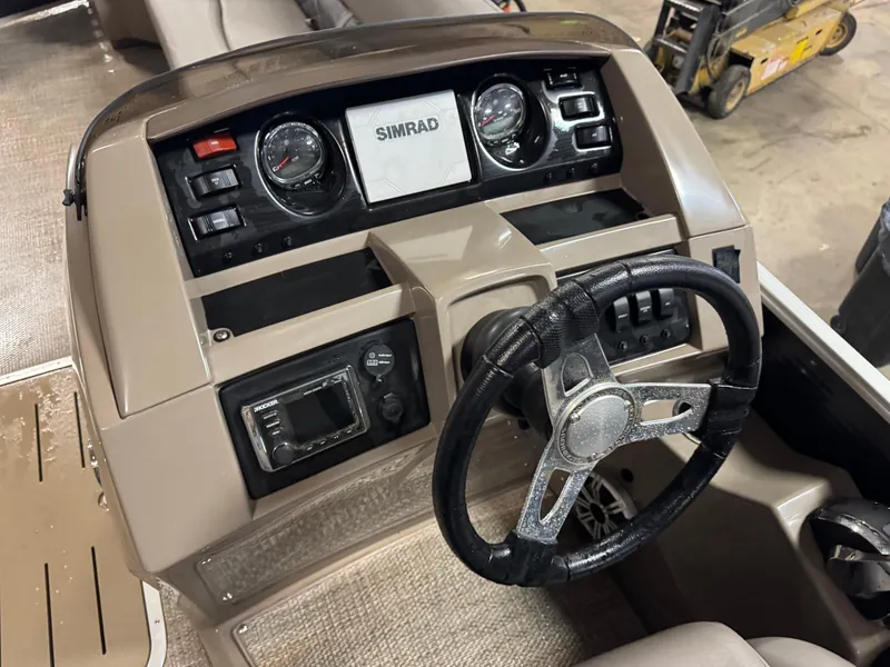 Slide: The Image of 2018 Bennington 25 SSXAPG boat dashboard with Simrad display and steering wheel. - 15