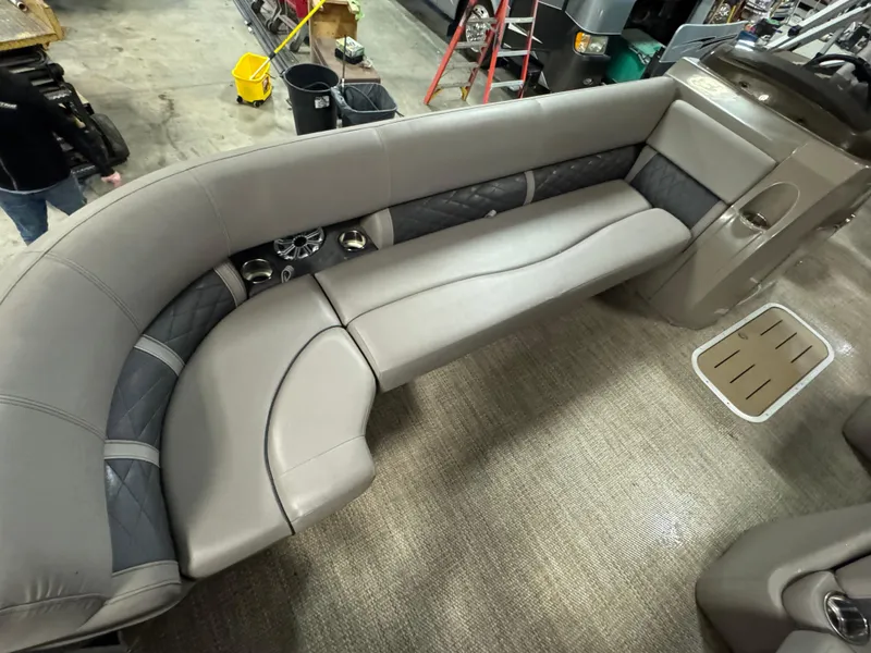 Slide: The Image of 2018 Bennington 25 SSXAPG boat interior with gray cushioned seating and cup holders. - 18