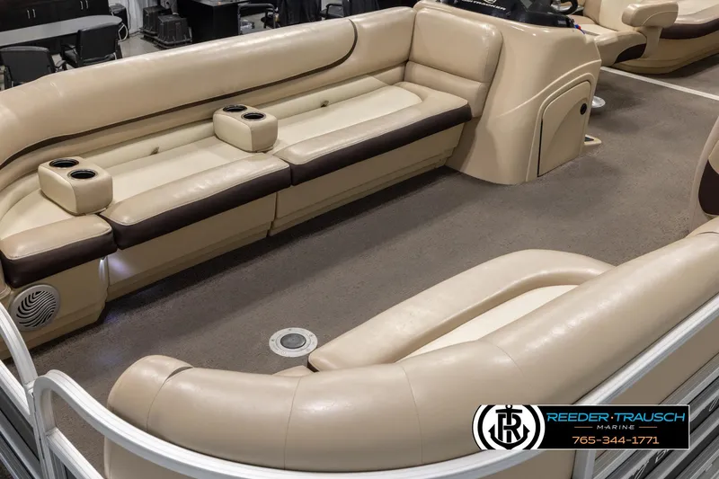 Slide: The Image of 2016 Sun Tracker 24 Party Barge interior with beige seating and cup holders. - 10