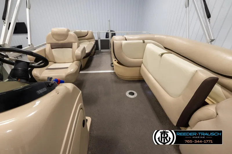 Slide: The Image of Interior of 2016 Sun Tracker 24 Party Barge with beige seating and steering console. - 15