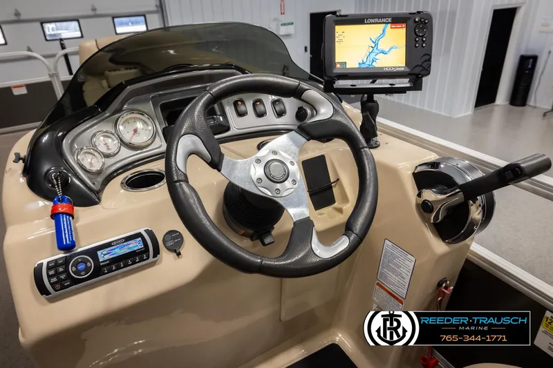 Slide: The Image of 2016 Sun Tracker 24 Party Barge dashboard with steering wheel and navigation system. - 25