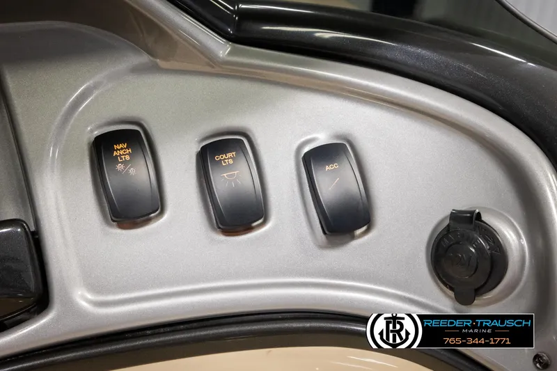 Slide: The Image of Control panel of 2016 Sun Tracker 24 Party Barge with labeled switches and accessory port. - 29