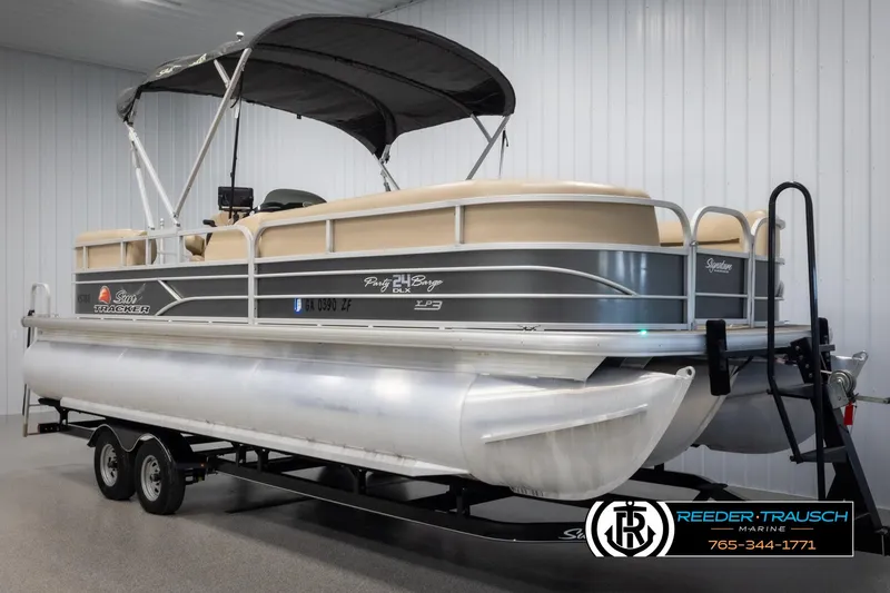 Slide: The Image of 2016 Sun Tracker 24 Party Barge pontoon boat on trailer in indoor storage. - 3
