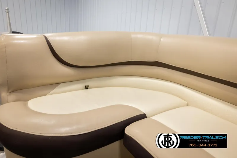 Slide: The Image of 2016 Sun Tracker 24 Party Barge interior seating with beige and brown upholstery. - 36