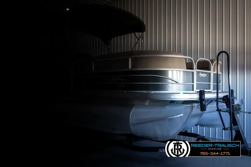 Slide: The Image of 2016 Sun Tracker 24 Party Barge pontoon boat in storage, partially illuminated. - 4