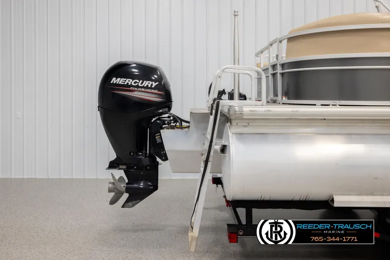 Slide: The Image of 2016 Sun Tracker 24 Party Barge with Mercury outboard motor in a showroom. - 42