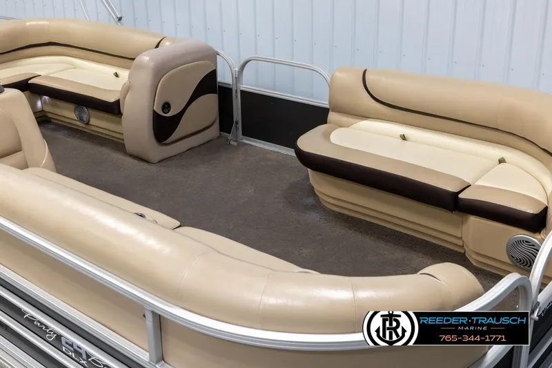 Slide: The Image of 2016 Sun Tracker 24 Party Barge interior with beige seating and carpeted floor. - 9