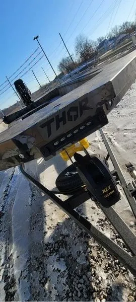 Slide: The Image of 2023 Thor Lake Hammer 1754 Deluxe boat on trailer, snowy background. - 6