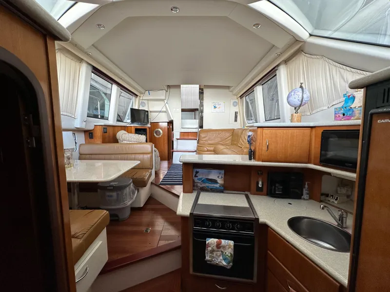 Slide: The Image of Interior of 2003 Carver 356 Motor Yacht, featuring kitchen and seating area. - 10