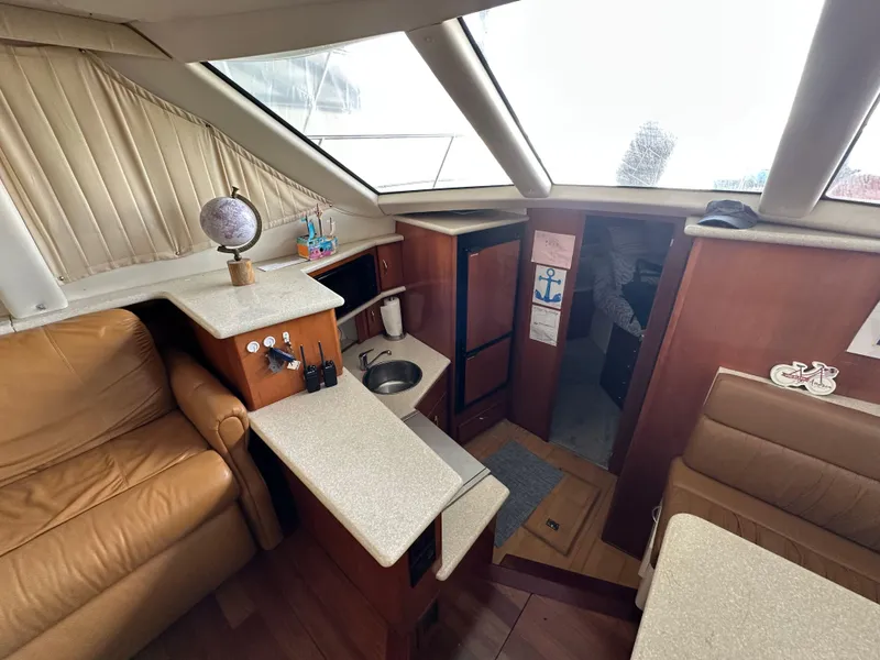 Slide: The Image of Interior of 2003 Carver 356 Motor Yacht with seating, kitchenette, and nautical decor. - 11