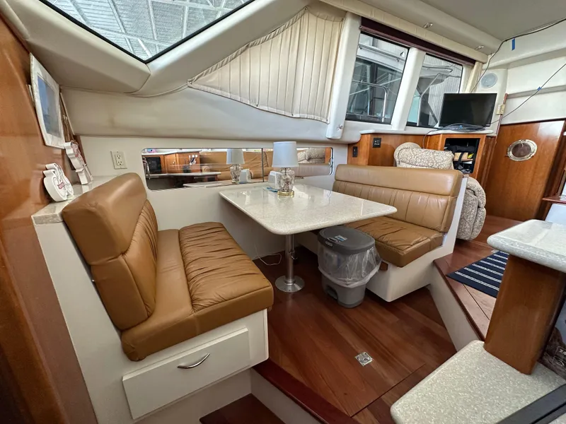 Slide: The Image of Interior of 2003 Carver 356 Motor Yacht with dining area and leather seating. - 12