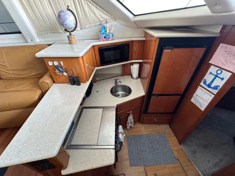 Slide: The Image of Interior of 2003 Carver 356 Motor Yacht kitchen with sink, microwave, and fridge. - 13