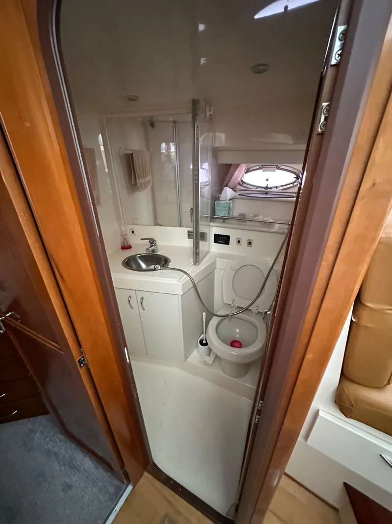 Slide: The Image of 2003 Carver 356 Motor Yacht bathroom with sink, toilet, and shower. - 14