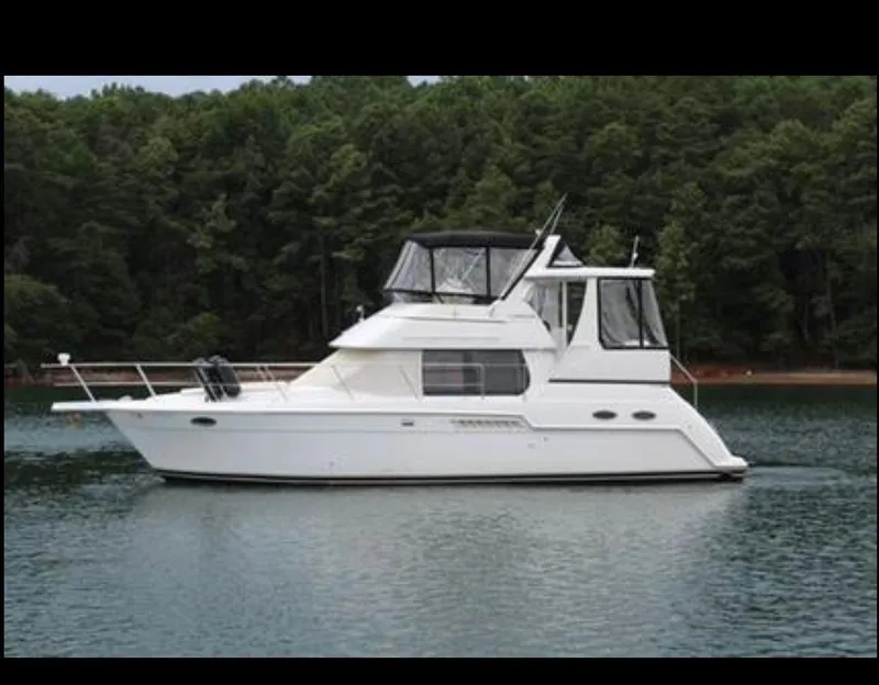 Slide: The Image of 2003 Carver 356 Motor Yacht on a serene lake with forest backdrop. - 2