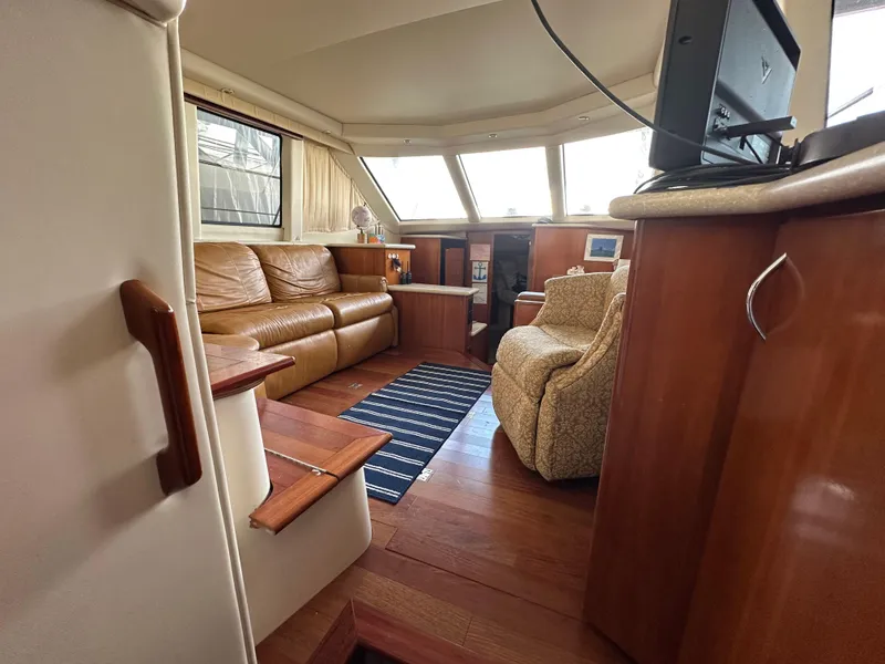 Slide: The Image of Interior of 2003 Carver 356 Motor Yacht with leather seating and wood accents. - 21