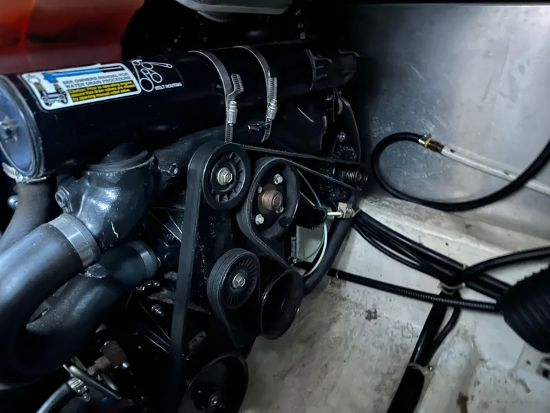 Slide: The Image of Engine compartment of a 2003 Carver 356 Motor Yacht, showcasing belts and hoses. - 25