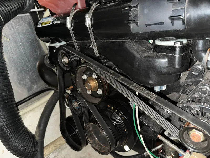 Slide: The Image of Engine components of a 2003 Carver 356 Motor Yacht, featuring belts and pulleys. - 26
