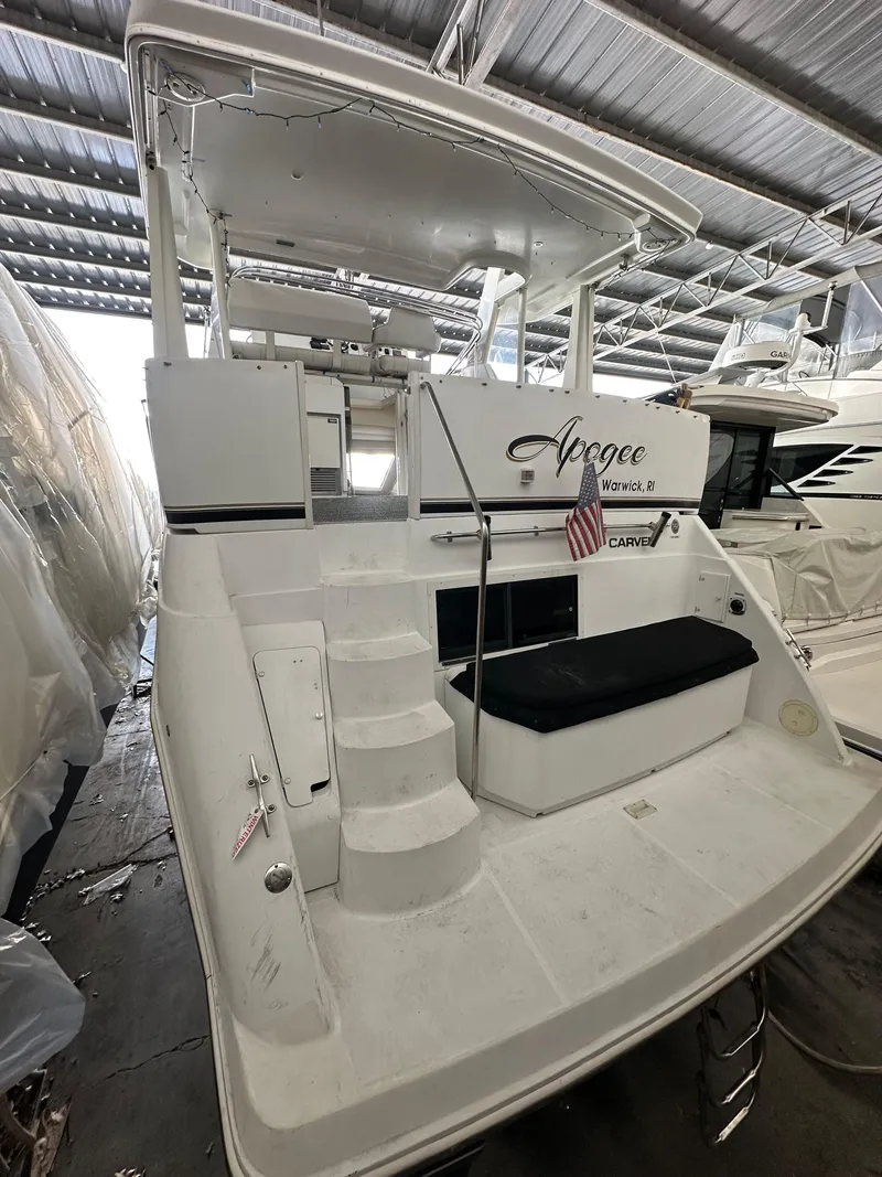 Slide: The Image of 2003 Carver 356 Motor Yacht in marina, featuring spacious deck and seating area. - 3