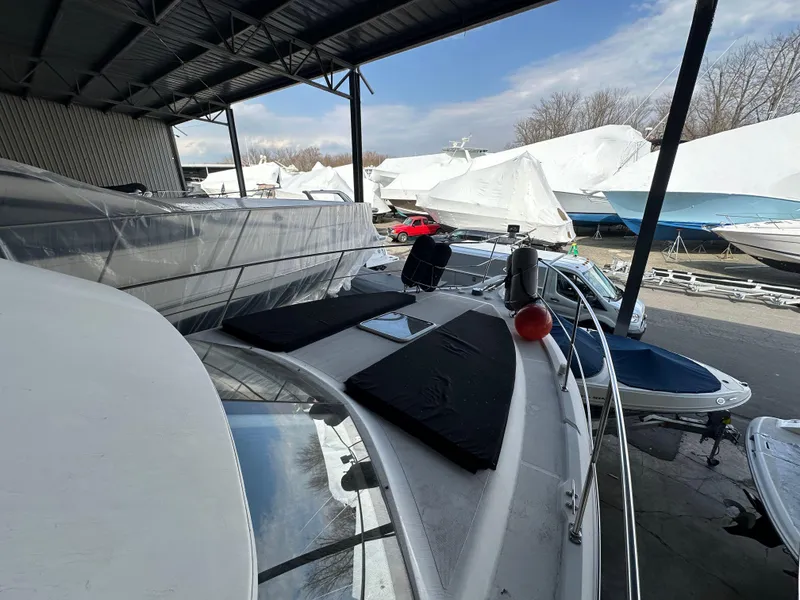 Slide: The Image of 2003 Carver 356 Motor Yacht docked under a covered marina with other boats nearby. - 34