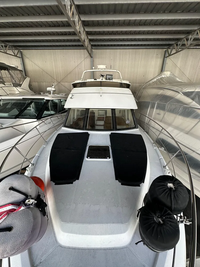 Slide: The Image of 2003 Carver 356 Motor Yacht in storage, featuring sleek design and spacious deck. - 35