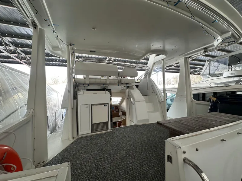 Slide: The Image of 2003 Carver 356 Motor Yacht interior with stairs and seating area under a covered dock. - 4