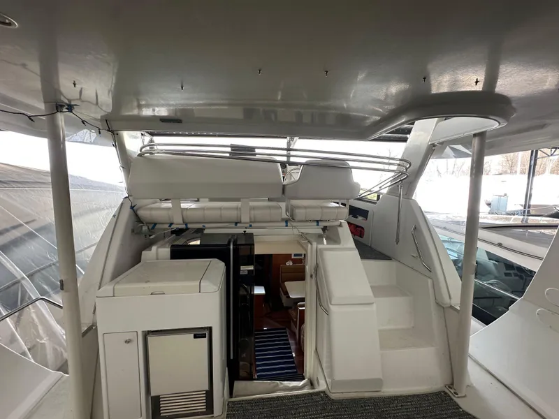 Slide: The Image of 2003 Carver 356 Motor Yacht interior with stairs and compact kitchenette. - 6