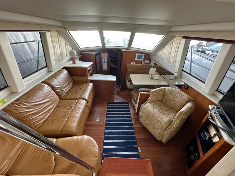 Slide: The Image of Interior of 2003 Carver 356 Motor Yacht with leather seating and dining area. - 7