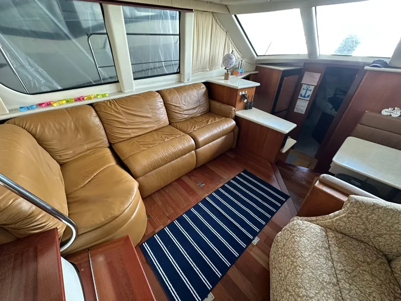 Slide: The Image of Luxurious interior of 2003 Carver 356 Motor Yacht with leather seating and wood accents. - 8