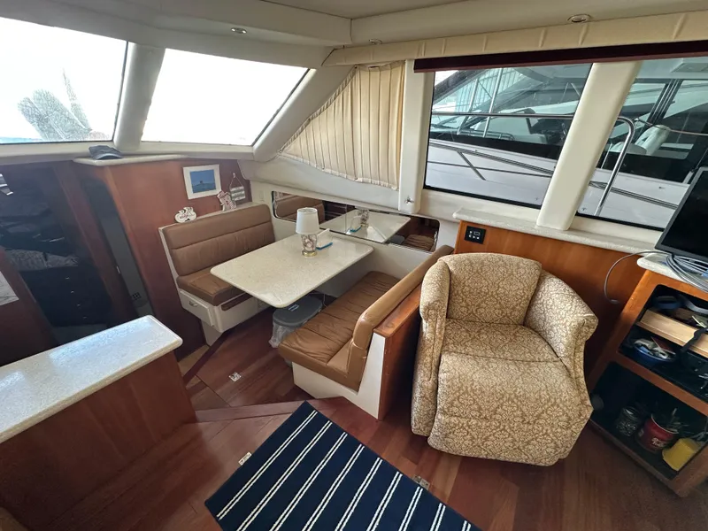 Slide: The Image of 2003 Carver 356 Motor Yacht interior with dining area and seating. - 9