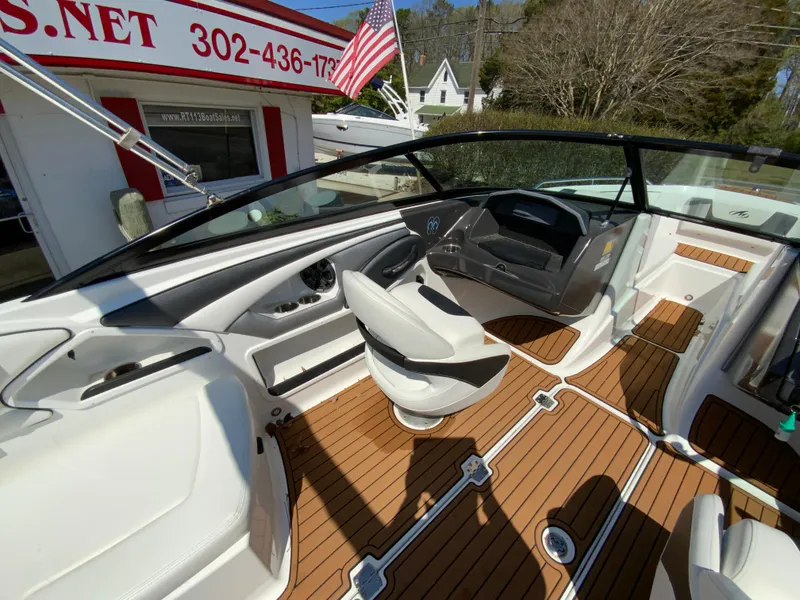 Slide: The Image of 2017 Monterey 217 Outboard boat interior with wood flooring and modern dashboard. - 11