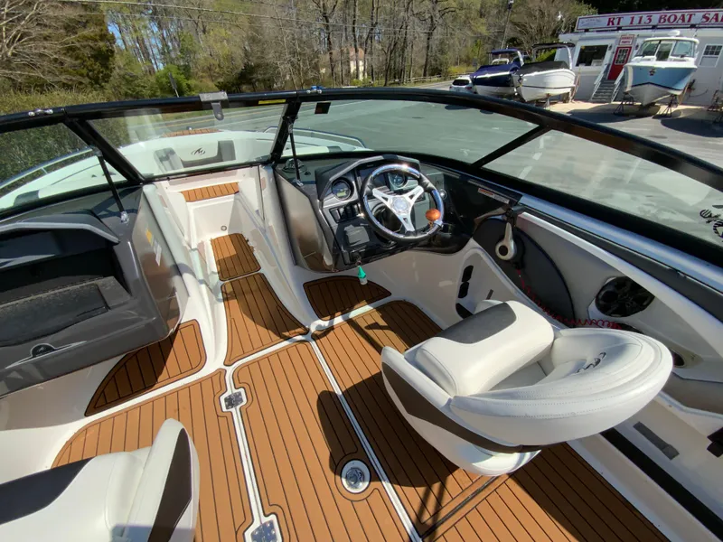 Slide: The Image of 2017 Monterey 217 Outboard boat interior with wood flooring and modern steering console. - 12