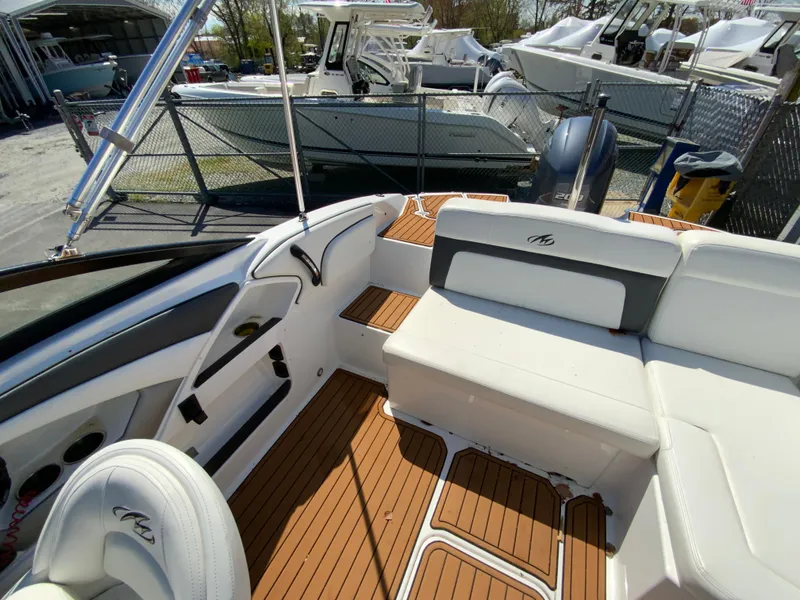 Slide: The Image of 2017 Monterey 217 Outboard boat interior with white seating and teak flooring. - 13