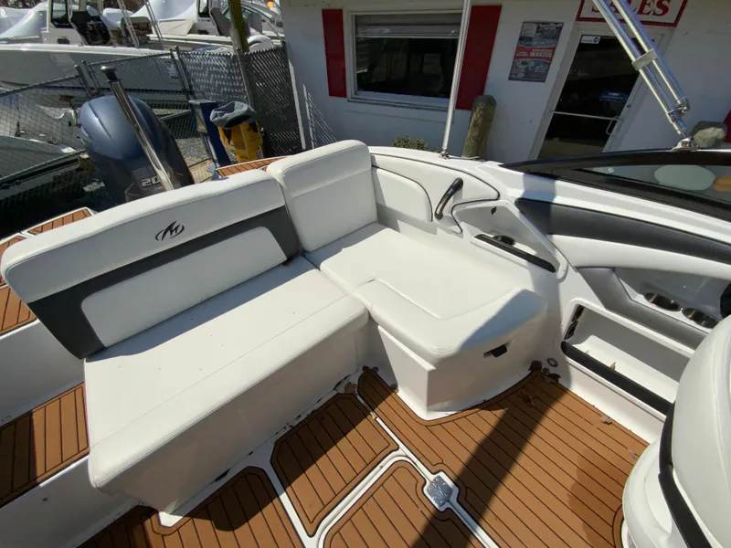 Slide: The Image of 2017 Monterey 217 Outboard boat interior with white seating and teak flooring. - 14