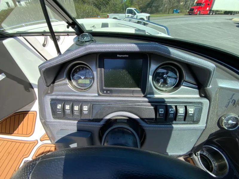 Slide: The Image of Dashboard of a 2017 Monterey 217 Outboard boat with gauges and controls. - 16