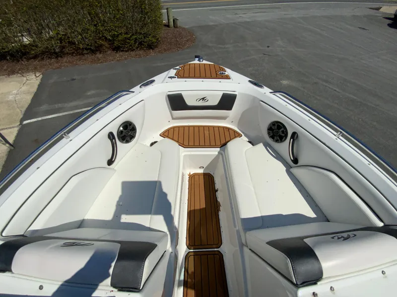 Slide: The Image of 2017 Monterey 217 Outboard boat interior with white seating and wood accents. - 19