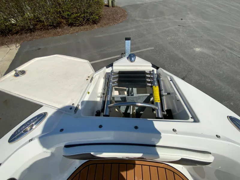Slide: The Image of 2017 Monterey 217 Outboard boat with open storage compartment and ladder on deck. - 20